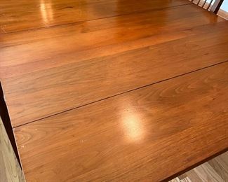 Black walnut drop-leaf dining room table with 6 chairs