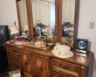 Dresser with mirror, ladies vanity accessories, hats, and books