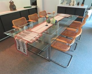 Chrome base glass top dining table (84"x 40"); Set of (6) Knoll Marcel Breuer Cesca chrome arm chairs, caned seats/backs.