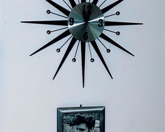 Black and Silver Starburst Clock 

Elvis Presley young and relaxed framed immediately below 