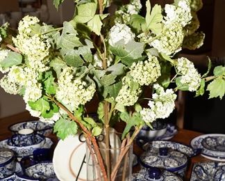 Faux florals in tall glass vase