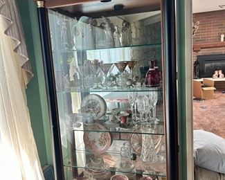 7 ft. high walnut display/china cabinet with plate rail, glass shelves.