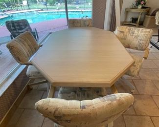 $250 Table with 4 chairs on casters and leaf