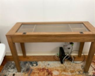 This table could be used in an entry or console table. Top lifts up so you can display your collectibles 