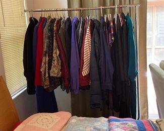 One of 4 racks of clothing and hand bags. 