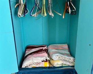 Inside wardrobe, many blankets, throws and linen throughout home