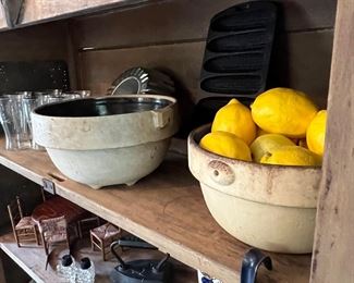 Pie safe is filled with wooden spoons, crock bowls and kitchen items