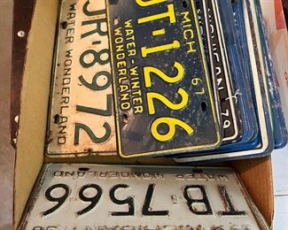 Box of vintage license plates