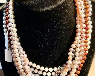 Elsa Schiaparelli earrings and pearls. 