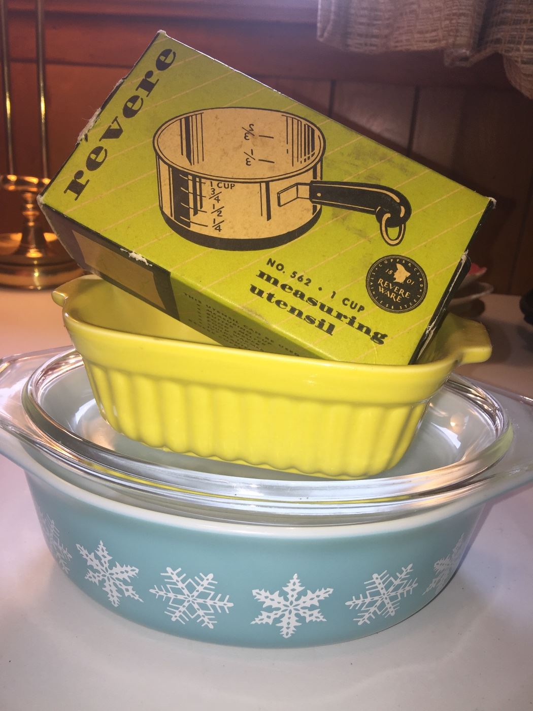 An often sought Pyrex snowflake casserole dish, a newer yellow baking dish and vintage RevereWare measure are great ways to add old-fashioned charm yo any kitchen. 