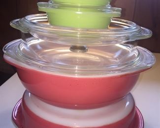 Pyrex is the showy workhorse in many kitchen. Here, Flamingo Pink Pyrex baking dishes, a classic clear glass casserole and light green personal casseroles. 