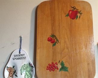 Use the backside of the cutting board to retain the fruit decals. The spoon rest is pretty enough to display or use as intended. 