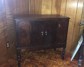 An antique cabinet with two doors is an ideal place to stow books, sewing supplies, puzzles and more. 