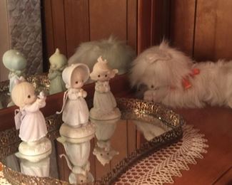 Precious Moments figurines look even more delicate next to a fuzzy plush kitty. 