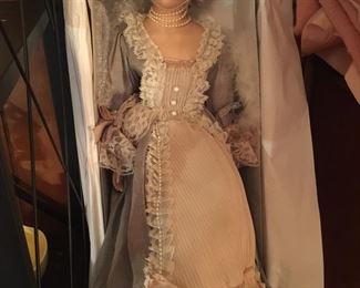This porcelain gal sports a hoop under her fancy dress. Despite her formal look, she might not have ever made it out of her original box. 
