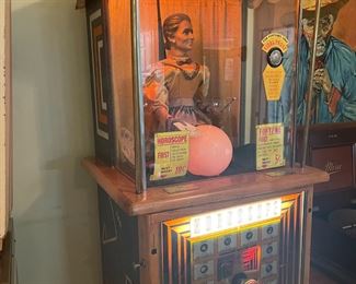 1957 Genco Horoscope, Fortune Teller machine. Works great! 
-Measures 80" Tall, 22" Deep and 23" Wide. Includes Keys!
Description: A dime for the horoscope and a nickel for the fortune. When you a nickel or a dime, the Genco Horoscope Grandma moves her head, moves both hands, and breathes. The hoppers inside rotates until the right scroll horoscope is delivered into the tray out front. There are thirteen different drawers, one for each of the twelve month horoscope rolls, and a 13th drawer for the fortune roll. The horoscopes and fortunes are rolled up into small plastic tubes. If a nickel is inserted a fortune is dispensed. If a dime is inserted, the user selected horoscope (or fortune!) is dispensed. Many Genco Horoscope Grandmas have a modification - if a fortune only is requested, grandma again moves and the glowing ball lights up "yes" or "no" for the fortune.