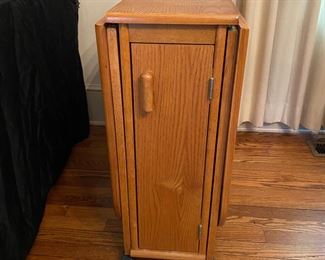 F13 - $50. Drop leaf table on wheels that stores 4 folding chairs inside. Measures 10.25" wide with leaves down. 34" long x 29.5" tall. Each leaf adds 25.5" (61" long with leaves up)