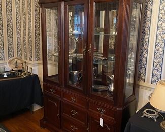 F8 - $125. China Cabinet. Moves in 2 pieces. Measures 16.5" deep x 54" wide x 85" tall. Has 2 glass shelves and it is lighted. 