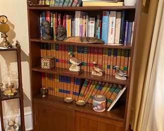 F18 - $60. Wooden bookcase with 2 sliding doors on the bottom. Measures 36.25" wide x 13" deep x 63" tall. 