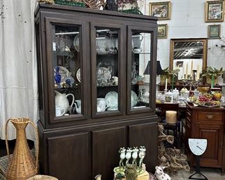 Contemporary Lighted Oak china cabinet with an expresso stain, glass shelves and solid doors on base. 