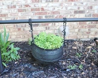 16 - Cast Iron Stew Post with Holder Bring help to remove Holder: 52" x 32" Pot: 15" x 9"
