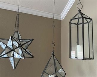 Hanging glass candleholders. Each comes with the hanger, the candle holder itself, and a candle.