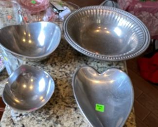 The largest bowl is pewter. The other three bowls are from Nambe.!