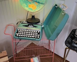 So many cool things in this house. The vintage typewriter is in perfect/mint condition. And the globe is so cool and lights up. The pink item you see is actually a vinyl record holder.