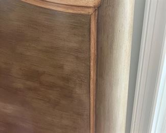 The color of the bed frame is a muted grayish brushed bronze with tan trim