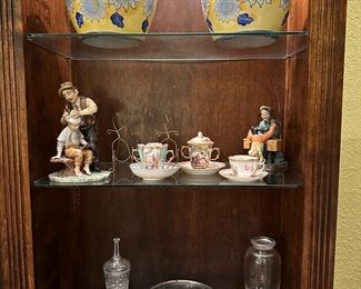 The tea cups and figurine on the left are sold.