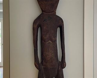 Hand-Carved Papua New Guinea Primitive Sculpture of Man with Cowrie Eyes. Measures 9" W x 44" H. Photo 1 of 3.