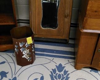 Oak wall cabinet with beveled mirror, blue and white carpet, tole painted waste basket