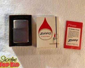 Vintage Zippo Lighter in original box. No. 200 Brush finish, unfired. Includes original booklet.
