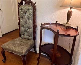 Entry foyer with a lovely antique button, chart, slipper chair, and a beautiful shell inlay two-tier table