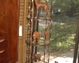 Carved wooden animals on metal and glass shelf
