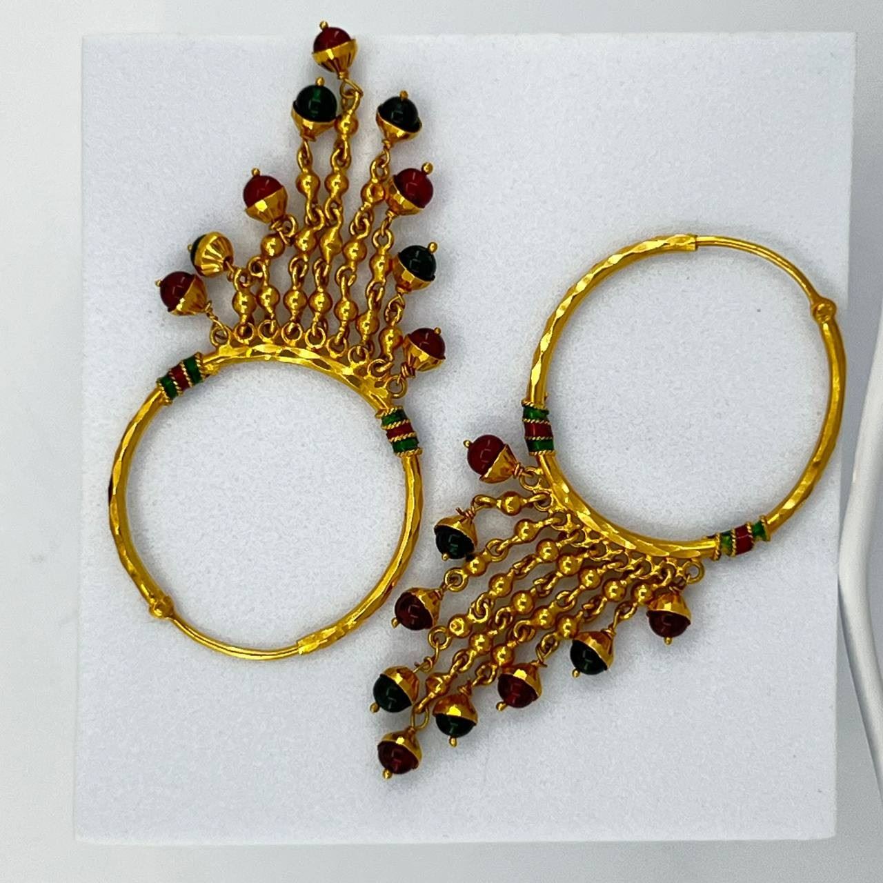 An Indian 13 gr of 22K gold loop Earring with charms. Red & green stones. $780
