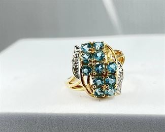 A 14K yellow gold ring with multiple blue diamonds & white diamonds. 4.00 gr. $180.-