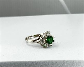 14K white gold, flower shape ring with Emerald & CZ stone. 2.70 gr.      $130.-