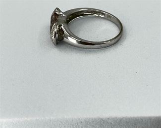 14K white gold ring with pink sapphire stone and diamonds. 3.4 gr. $155.-