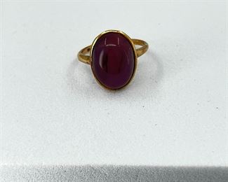 14K yellow gold ring with oval shape purple stone. 2.7 gr. $120.-