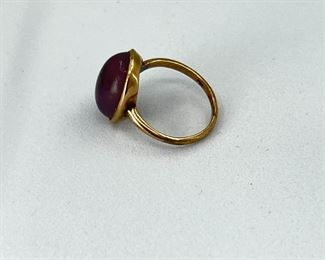14K yellow gold ring with oval shape purple stone. 2.7 gr. $120.-