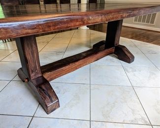 "SLEEPER-WOOD" BURMESE TEAK DINING TABLE
● In the 1800’s the British brought railroad transportation to southern Africa. But because of a lack of reliable local timber, they imported much of the wood needed for the railroad ties from
British colonies elsewhere. 
● By the 1990's, these railroad ties (British call them “Sleepers”) finally began being replaced by concrete sleepers.
● Local furniture artisans bought huge piles of these old sleepers as they were made from ancient tropical hardwoods - Teak from Burma being one of the most
prized. The rustic furniture made from the railroads thus became locally known as Sleeper Wood Furniture.
● Having survived 150 years underground in Africa with borer-beetles gnawing at them and steam locomotives dropping coal on them, these pieces were custom-made for a South African immigrant to the US. None of this furniture has ever seen urethane, polish or stain on them. The wood oils protect it naturally, but an occasional wipe with mineral oil (o