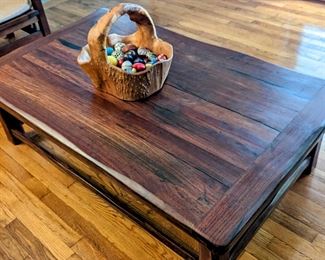 BURMESE TEAK COFFEE TABLE
● In the 1800’s the British brought railroad transportation to southern Africa. But because of a lack of reliable local timber, they imported much of the wood needed for the railroad ties from
British colonies elsewhere. 
● By the 1990's, these railroad ties (British call them “Sleepers”) finally began being replaced by concrete sleepers.
● Local furniture artisans bought huge piles of these old sleepers as they were made from ancient tropical hardwoods - Teak from Burma being one of the most
prized. The rustic furniture made from the railroads thus became locally known as Sleeper Wood Furniture.
● Having survived 150 years underground in Africa with borer-beetles gnawing at them and steam locomotives dropping coal on them, these pieces were custom-made for a South African immigrant to the US. None of this furniture has ever seen urethane, polish or stain on them. The wood oils protect it naturally, but an occasional wipe with mineral oil
