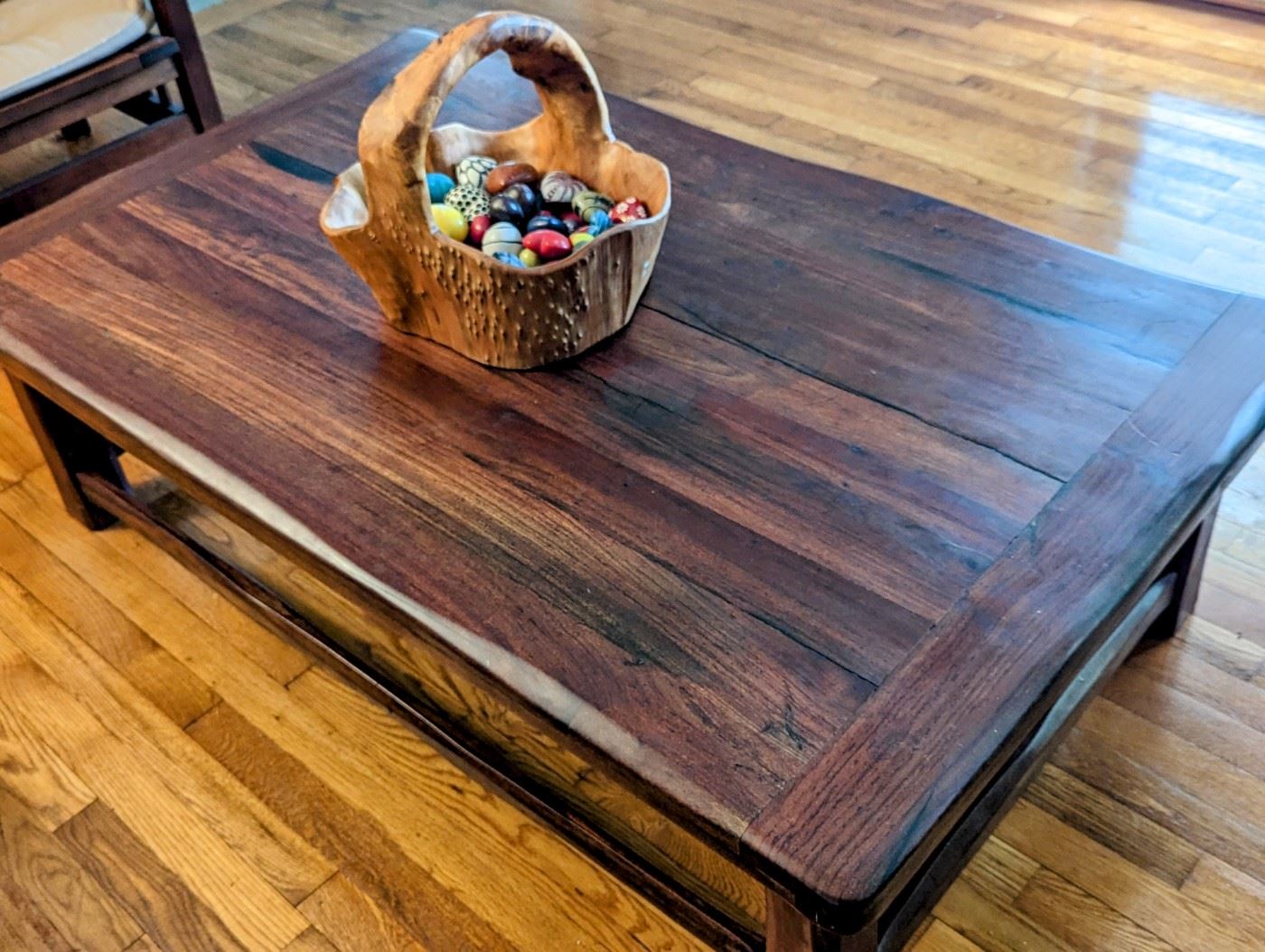 BURMESE TEAK COFFEE TABLE
● In the 1800’s the British brought railroad transportation to southern Africa. But because of a lack of reliable local timber, they imported much of the wood needed for the railroad ties from
British colonies elsewhere. 
● By the 1990's, these railroad ties (British call them “Sleepers”) finally began being replaced by concrete sleepers.
● Local furniture artisans bought huge piles of these old sleepers as they were made from ancient tropical hardwoods - Teak from Burma being one of the most
prized. The rustic furniture made from the railroads thus became locally known as Sleeper Wood Furniture.
● Having survived 150 years underground in Africa with borer-beetles gnawing at them and steam locomotives dropping coal on them, these pieces were custom-made for a South African immigrant to the US. None of this furniture has ever seen urethane, polish or stain on them. The wood oils protect it naturally, but an occasional wipe with mineral oil