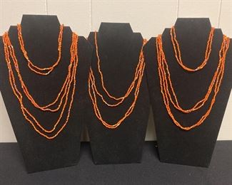 Eight Orange Beaded Necklaces