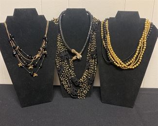 Four Black and Gold Colored Necklaces