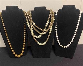 Three White And Gold Colored Necklaces