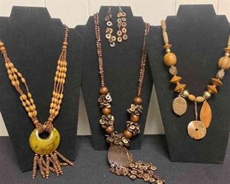 Three Wooden Like Necklaces And One Pair Of Earrings
