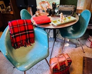 Chromcraft Fiberglass Shell Chairs, two with arms and two without, 
Turquoise; 4 in total. No cracks 
Herman Miller Mini-Round Conference Table, 36-inch with Wood Grain Laminate Top - has original Herman Miller Sticker on underside of table, designed by Charles Eames.  