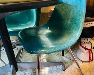 Chromcraft Fiberglass Shell Chairs, two with arms and two without, 
Turquoise; 4 in total. No cracks 
Herman Miller Mini-Round Conference Table, 36-inch with Wood Grain Laminate Top - has original Herman Miller Sticker on underside of table, designed by Charles Eames.  